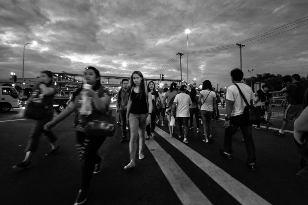 Girls crossing the road in Angeles City. The city is known as a main source of entertainment in the Philippines. Prices for women in go-go bars vary depending on the venue.
